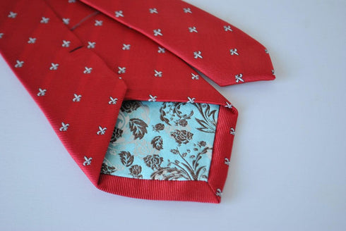 red tie with fleur de lis pattern
