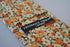cotton tie with orange and brown floral design