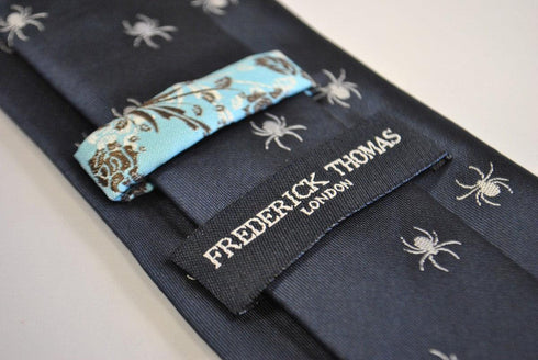 navy tie with white spider silhouette design