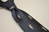 navy blue tie with archer silhouette design