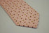 pink tie with red, green and white polka dots