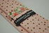 pink tie with red, green and white polka dots