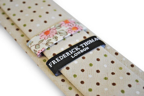 beige tie with green, red and white polka dots