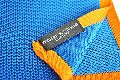 royal blue knitted pocket square with orange edging