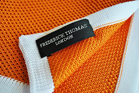 orange knitted pocket square with white edging