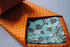 orange tie with black polka dots