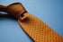 orange tie with black polka dots