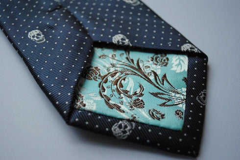 navy blue tie with embroidered white skulls design