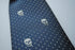navy blue tie with embroidered white skulls design