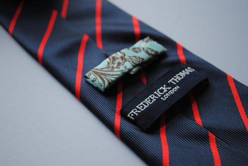 navy blue tie with thin red stripes