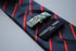 navy blue tie with thin red stripes