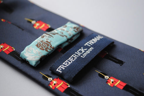 navy tie with royal queens guards pattern