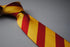 yellow and red barber striped tie