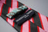 pink, red and black stripe tie