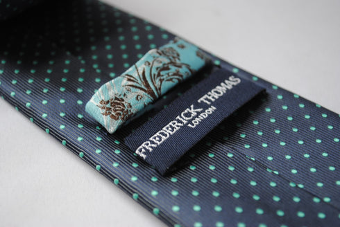 grey tie with turquoise pin spots