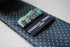 grey tie with turquoise pin spots