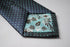 grey tie with turquoise pin spots