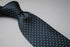 grey tie with turquoise pin spots