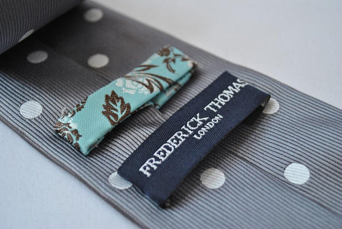 grey tie with white polka dots