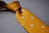 yellow tie with white polka dots