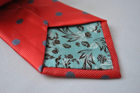 red tie with grey polka spots
