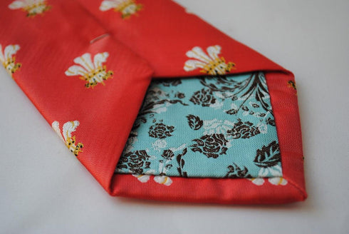 red tie with prince of wales feathers badge