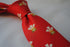 red tie with prince of wales feathers badge