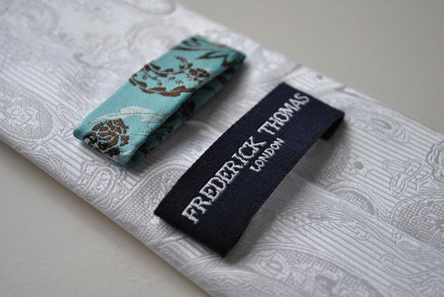 silver tie with paisley design