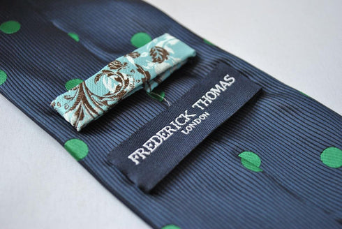 navy blue tie with green polka dots