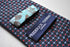 navy tie with red and light blue pin spots