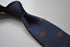 navy blue tie with stegosaurus dinosaur design