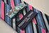 pink, blue and black striped tie