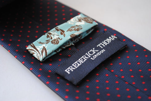 navy and red pin spot design tie