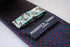 navy and red pin spot design tie