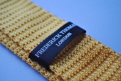 yellow gold skinny knitted tie with white polka dots
