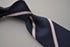 navy blue tie with white and pink stripes