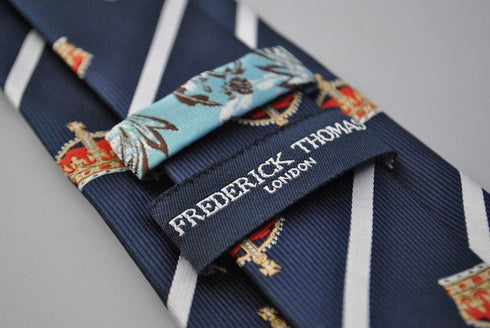 navy blue tie with crown design and white stripes