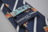navy blue tie with crown design and white stripes