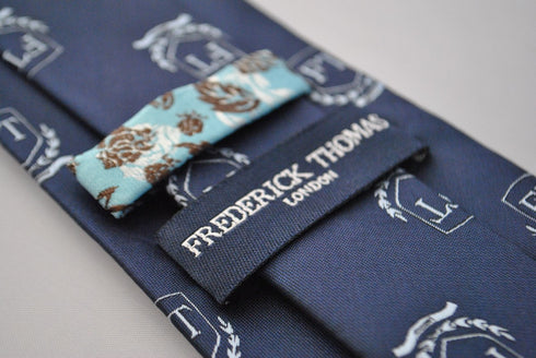 navy tie with Frederick Thomas crest