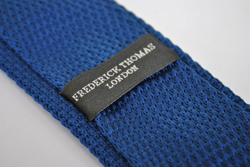 navy blue skinny knitted tie with pink polka dots with pointed end