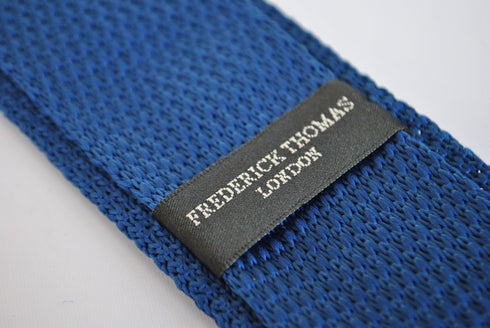 navy blue skinny knitted tie with pink polka dots with pointed end