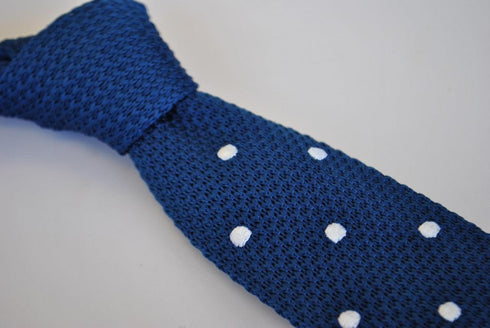 navy blue skinny knitted tie with white polka dots and pointed end