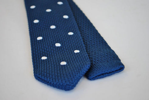 navy blue skinny knitted tie with white polka dots and pointed end