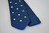 navy blue skinny knitted tie with white polka dots and pointed end
