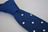 navy blue skinny knitted tie with white polka dots and pointed end