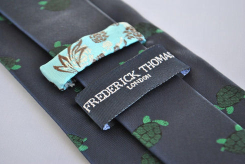 navy tie with green turtle design