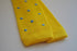 yellow skinny knitted tie with light blue polka dots