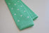 mint green skinny knitted tie with white polka dots