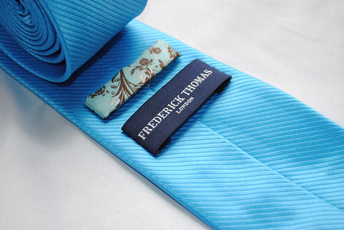 bright turquoise plain tie with a very subtle stripe